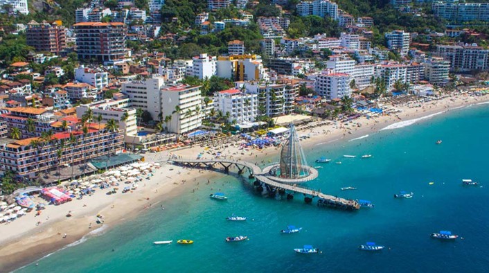 Puerto-Vallarta-gay-travel-Los-Muertos-beach-blue-chairs-condos-for-sale